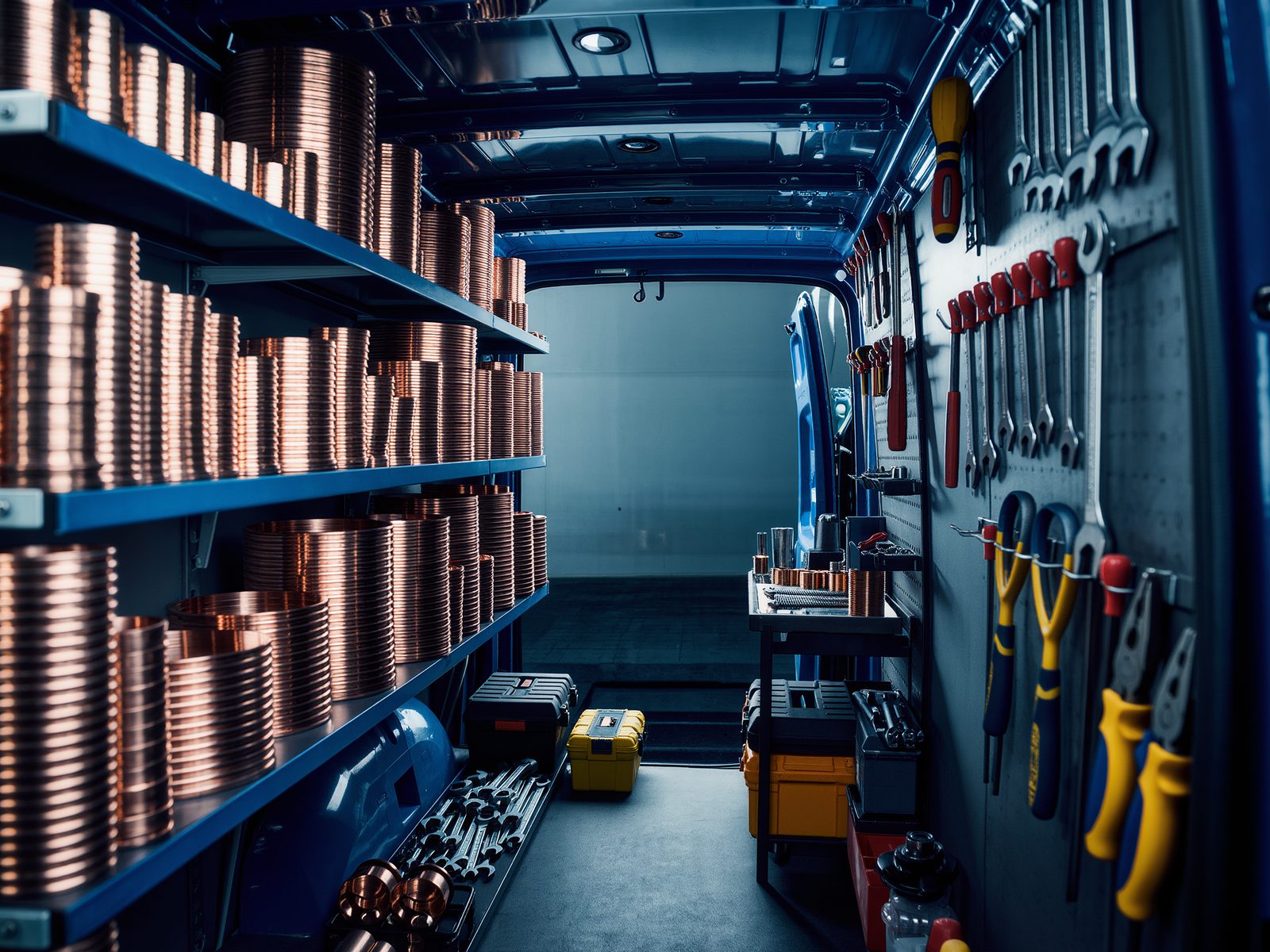 Work van interior with shelves of neatly organised copper fittings and tools